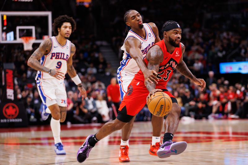 TORONTO, CANADA - OCTOBER 25: Jamal Shead #23 of the Toronto Raptors dribbles as he's defended by Tyrese Maxey #0 of the Philadelphia 76ers during the second half of their NBA game at Scotiabank Arena on October 25, 2024 in Toronto, Ontario, Canada. NOTE TO USER: User expressly acknowledges and agrees that, by downloading and or using this photograph, User is consenting to the terms and conditions of the Getty Images License Agreement. (Photo by Cole Burston/Getty Images)