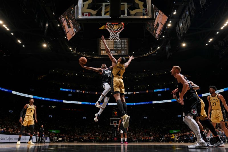 TORONTO, CANADA - JANUARY 26: Terance Mann #14 of the LA Clippers drives to the basket during the game against the Toronto Raptors on January 26, 2024 at the Scotiabank Arena in Toronto, Ontario, Canada.  NOTE TO USER: User expressly acknowledges and agrees that, by downloading and or using this Photograph, user is consenting to the terms and conditions of the Getty Images License Agreement.  Mandatory Copyright Notice: Copyright 2024 NBAE (Photo by Mark Blinch/NBAE via Getty Images)