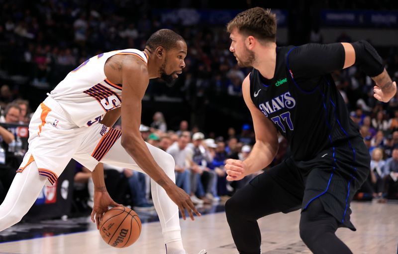 DALLAS, TX - FEBRUARY 22: Kevin Durant #35 of the Phoenix Suns handles the ball as Luka Doncic #77 of the Dallas Mavericks defends in the first half at American Airlines Center on February 22, 2024 in Dallas, Texas. NOTE TO USER: User expressly acknowledges and agrees that, by downloading and or using this photograph, User is consenting to the terms and conditions of the Getty Images License Agreement. (Photo by Ron Jenkins/Getty Images)