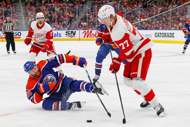 Jan 30, 2025; Edmonton, Alberta, CAN; Edmonton Oilers forward Connor Brown (28) falls while trying to knock the puck away from Detroit Red Wings defensemen Simon Edvinsson (77) during the first period at Rogers Place. Mandatory Credit: Perry Nelson-Imagn Images