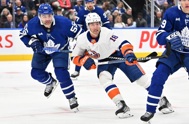 Feb 5, 2024; Toronto, Ontario, CAN;   New York Islanders forward Pierre Engvall (18) pursues the play in front of Toronto Maple Leafs defenseman Mark Giordano (55) in the second period at Scotiabank Arena. Mandatory Credit: Dan Hamilton-USA TODAY Sports