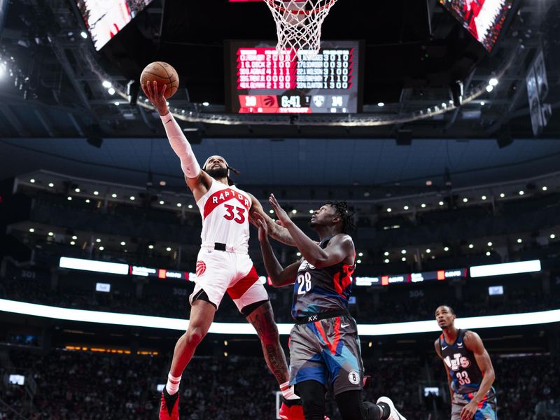 TORONTO, ON - MARCH 25: Gary Trent Jr. #33 of the Toronto Raptors goes to the basket against Dorian Finney-Smith #28 of the Brooklyn Nets during the first half of their basketball game at the Scotiabank Arena on March 25, 2024 in Toronto, Ontario, Canada. NOTE TO USER: User expressly acknowledges and agrees that, by downloading and/or using this Photograph, user is consenting to the terms and conditions of the Getty Images License Agreement. (Photo by Mark Blinch/Getty Images)