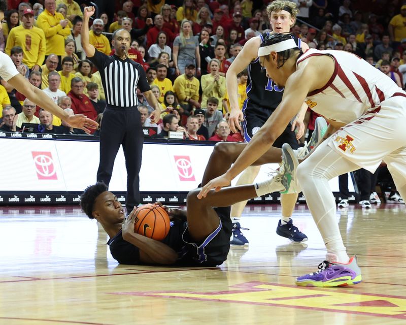 Mar 6, 2024; Ames, Iowa, USA; Brigham Young Cougars guard Jaxson Robinson (2) fights for a lose ball from Iowa State Cyclones forward Robert Jones (12) in the second half at James H. Hilton Coliseum. Mandatory Credit: Reese Strickland-USA TODAY Sports