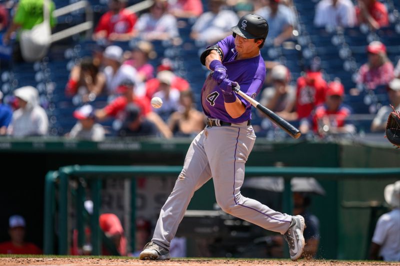 Jul 26, 2023; Washington, District of Columbia, USA; Colorado Rockies first baseman Michael Toglia (4) hits a home run during the sixth inning against the Washington Nationals at Nationals Park. Mandatory Credit: Reggie Hildred-USA TODAY Sports