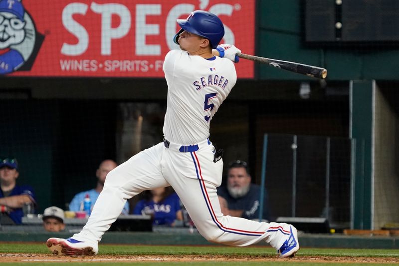 Jul 4, 2024; Arlington, Texas, USA; Texas Rangers shortstop Corey Seager (5) hits a double during the sixth inning against the San Diego Padres at Globe Life Field. Mandatory Credit: Raymond Carlin III-USA TODAY Sports