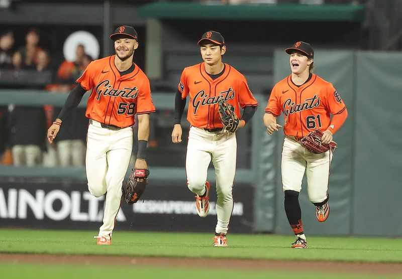 Sep 26, 2025; San Francisco, California, USA; against the San Francisco Giants outfielders jog infield after the game against the Colorado Rockies at Oracle Park. Mandatory Credit: Kelley L Cox-Imagn Images