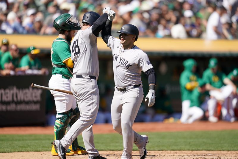 Sep 22, 2024; Oakland, California, USA; New York Yankees left fielder Jasson Dominguez (89) is congratulated by first baseman Anthony Rizzo (48) after hitting a two-run home run against the Oakland Athletics in the second inning at the Oakland-Alameda County Coliseum. Mandatory Credit: Cary Edmondson-Imagn Images