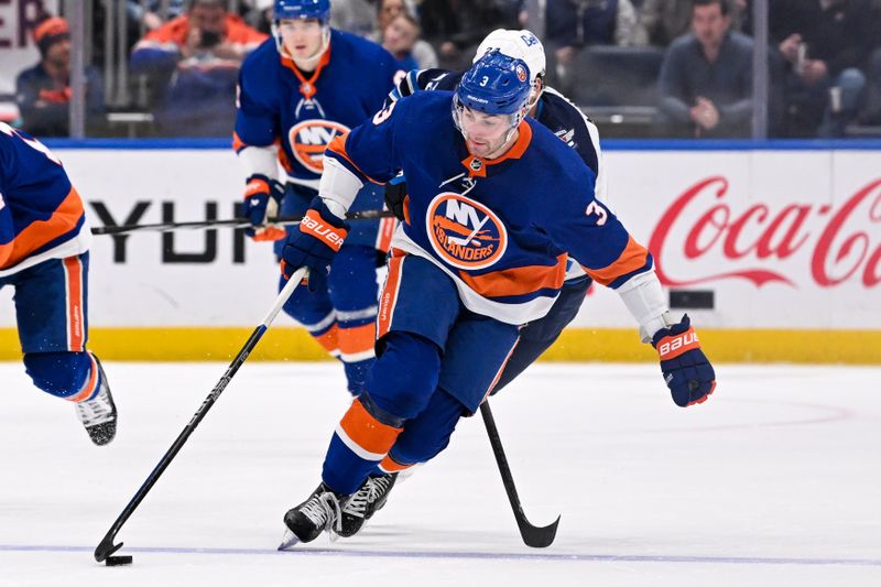 Mar 23, 2024; Elmont, New York, USA;  New York Islanders defenseman Adam Pelech (3) skates with the puck against the Winnipeg Jets during the second period at UBS Arena. Mandatory Credit: Dennis Schneidler-USA TODAY Sports