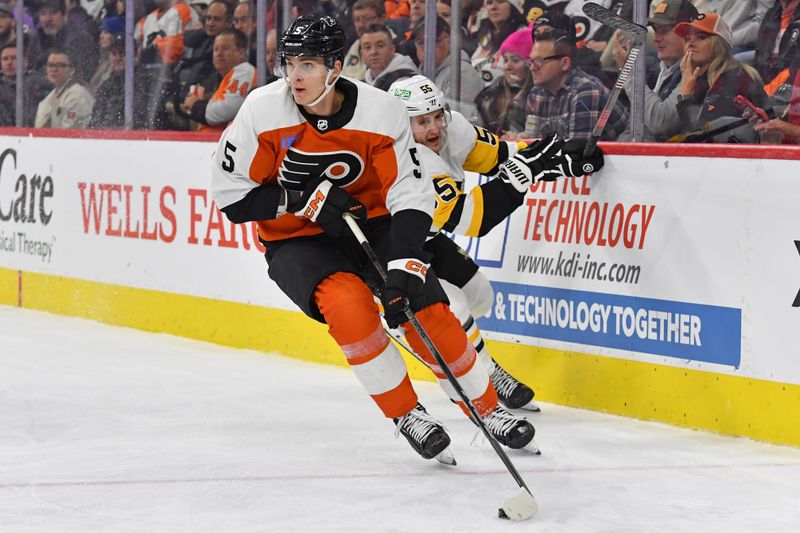 Jan 8, 2024; Philadelphia, Pennsylvania, USA; Philadelphia Flyers defenseman Egor Zamula (5) carries the puck past Pittsburgh Penguins center Noel Acciari (55) during the second period at Wells Fargo Center. Mandatory Credit: Eric Hartline-USA TODAY Sports