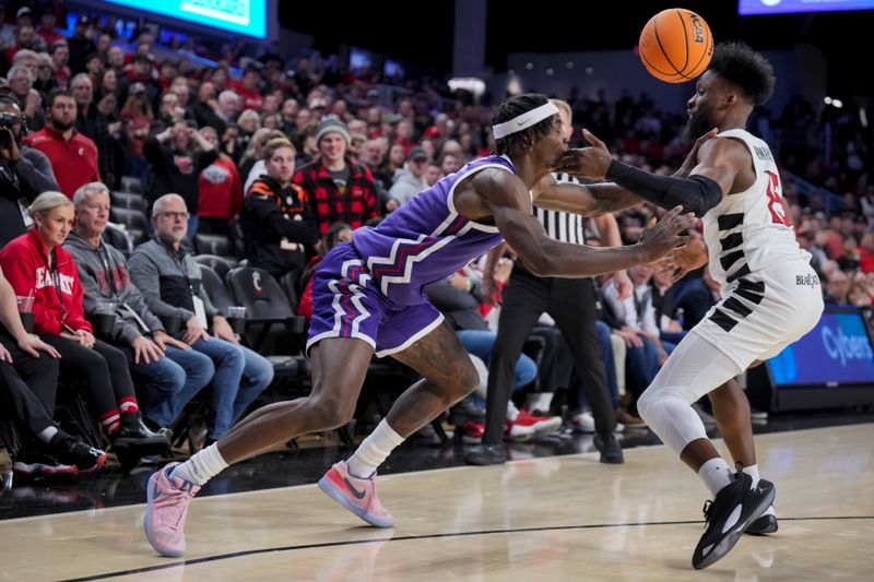 Jan 16, 2024; Cincinnati, Ohio, USA;  Cincinnati Bearcats forward John Newman III (15) steals the ball from TCU Horned Frogs forward Emanuel Miller (2) in overtime at Fifth Third Arena. Mandatory Credit: Aaron Doster-USA TODAY Sports