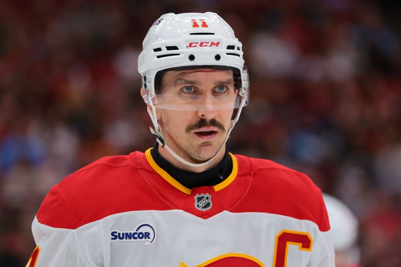 Nov 28, 2025; Sunrise, Florida, USA; Calgary Flames center Mikael Backlund (11) looks on against the Florida Panthers during the first period at Amerant Bank Arena. Mandatory Credit: Sam Navarro-Imagn Images