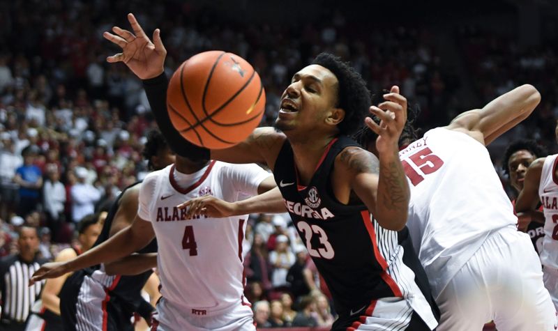 Feb 18, 2023; Tuscaloosa, Alabama, USA; Georgia center Braelen Bridges (23) loses the ball out of bounds as he fights Alabama forward Noah Clowney (15) for control of a rebound at Coleman Coliseum. Mandatory Credit: Gary Cosby Jr.-USA TODAY Sports