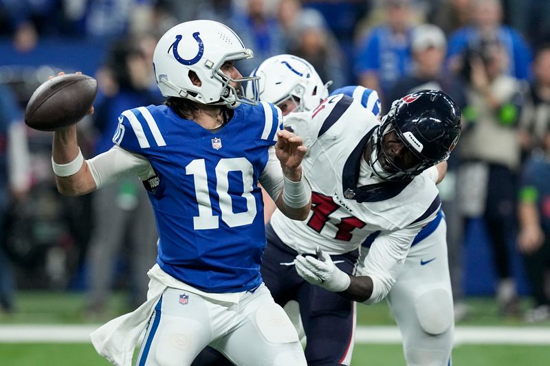 Indianapolis Colts quarterback Gardner Minshew (10) throws a pass as Houston Texans linebacker Myjai Sanders (41) closes in during the first half of an NFL football game Saturday, Jan. 6, 2024, in Indianapolis. (AP Photo/Darron Cummings)