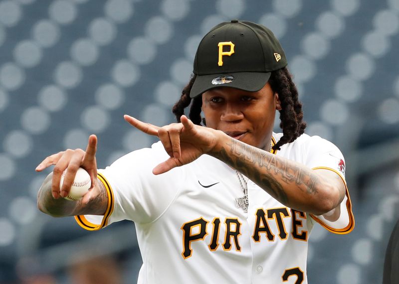 Apr 23, 2024; Pittsburgh, Pennsylvania, USA;  Recording artist Fedd the God reacts after throwing out a ceremonial first pitch before the Pittsburgh Pirates host the Milwaukee Brewers at PNC Park. Mandatory Credit: Charles LeClaire-USA TODAY Sports