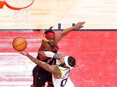 TORONTO, CANADA - DECEMBER 23:  Jordan Clarkson #00 of the Utah Jazz drives to the basket during the game as Precious Achiuwa #5 of the Toronto Raptors plays defense on December 23, 2023 at the Scotiabank Arena in Toronto, Ontario, Canada.  NOTE TO USER: User expressly acknowledges and agrees that, by downloading and or using this Photograph, user is consenting to the terms and conditions of the Getty Images License Agreement.  Mandatory Copyright Notice: Copyright 2023 NBAE (Photo by Vaughn Ridley/NBAE via Getty Images)