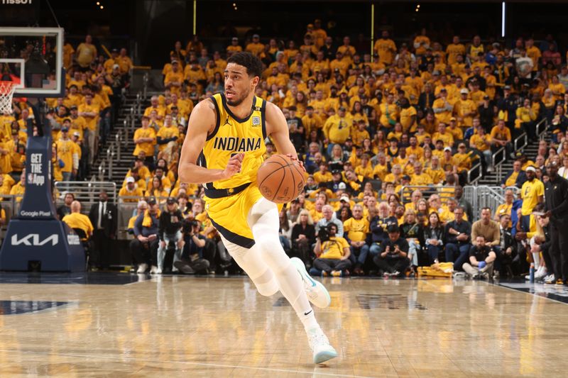 INDIANAPOLIS, IN - APRIL 26: Tyrese Haliburton #0 of the Indiana Pacers dribbles the ball during the game against the Milwaukee Bucks during Round 1 Game 3 of the 2024 NBA Playoffs on April 26, 2024 at Gainbridge Fieldhouse in Indianapolis, Indiana. NOTE TO USER: User expressly acknowledges and agrees that, by downloading and or using this Photograph, user is consenting to the terms and conditions of the Getty Images License Agreement. Mandatory Copyright Notice: Copyright 2023 NBAE (Photo by Nathaniel S. Butler/NBAE via Getty Images)