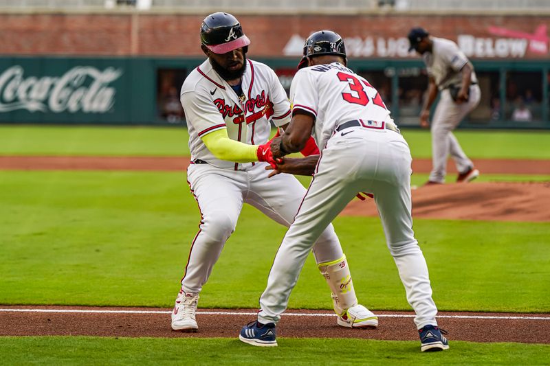 Aug 15, 2023; Cumberland, Georgia, USA; Atlanta Braves designated hitter Marcell Ozuna (20) reacts with third base coach Ron Washington (37) after hitting a home run against the New York Yankees during the first inning at Truist Park. Mandatory Credit: Dale Zanine-USA TODAY Sports