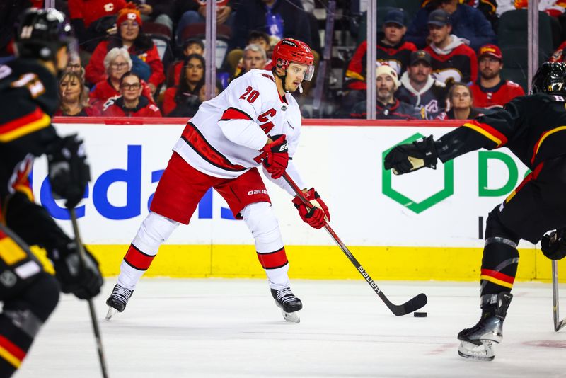 Oct 24, 2024; Calgary, Alberta, CAN; Carolina Hurricanes center Sebastian Aho (20) passes the puck against the Calgary Flames during the first period at Scotiabank Saddledome. Mandatory Credit: Sergei Belski-Imagn Images