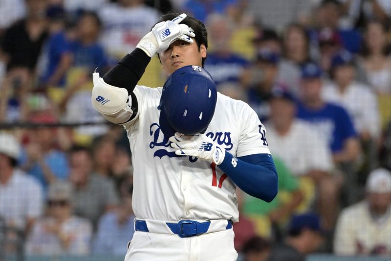 Aug 6, 2024; Los Angeles, California, USA;  Los Angeles Dodgers designated hitter Shohei Ohtani (17) adjusts his batting helmet in the third inning against the Philadelphia Phillies at Dodger Stadium. Mandatory Credit: Jayne Kamin-Oncea-USA TODAY Sports