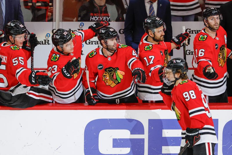 Mar 10, 2024; Chicago, Illinois, USA; Chicago Blackhawks center Connor Bedard (98) celebrates with teammates after scoring against the Arizona Coyotes during the second period at United Center. Mandatory Credit: Kamil Krzaczynski-USA TODAY Sports