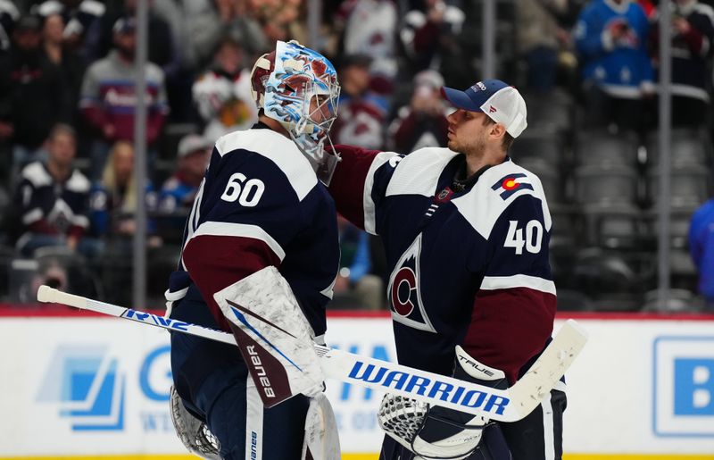 Mar 4, 2024; Denver, Colorado, USA; Colorado Avalanche goaltender Justus Annunen (60) and goaltender Alexandar Georgiev (40) celebrate defeating the Chicago Blackhawks  at Ball Arena. Mandatory Credit: Ron Chenoy-USA TODAY Sports