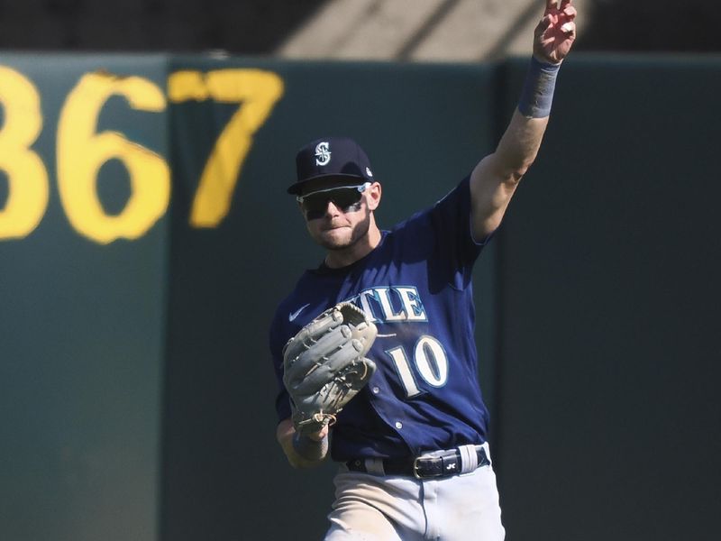 Sep 20, 2023; Oakland, California, USA; Seattle Mariners left field Jarred Kelenic (10) throws the ball during the ninth inning against the Oakland Athletics at Oakland-Alameda County Coliseum. Mandatory Credit: Kelley L Cox-USA TODAY Sports