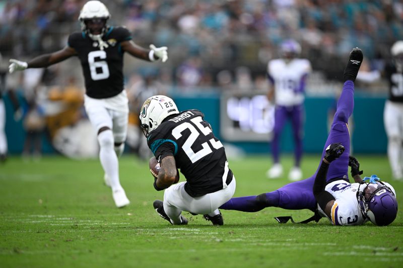 Jacksonville Jaguars cornerback Ronald Darby (25) intercepts a pass intended for Minnesota Vikings wide receiver Jordan Addison (3), right, during the second half of an NFL football game, Sunday, Nov. 10, 2024, in Jacksonville, Fla. (AP Photo/Phelan M. Ebenhack)