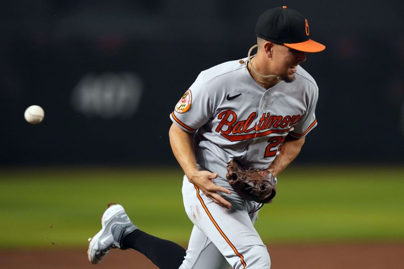 Sep 1, 2023; Phoenix, Arizona, USA; Baltimore Orioles third baseman Ramon Urias (29) misplays a ground ball against the Arizona Diamondbacks during the first inning at Chase Field. Mandatory Credit: Joe Camporeale-USA TODAY Sports