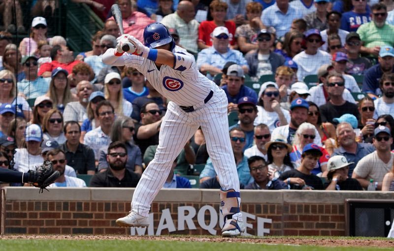 Jul 24, 2024; Chicago, Illinois, USA; Chicago Cubs outfielder Seiya Suzuki (27) jumps out of the way of an inside pitch against the Milwaukee Brewers during the third inning at Wrigley Field. Mandatory Credit: David Banks-USA TODAY Sports