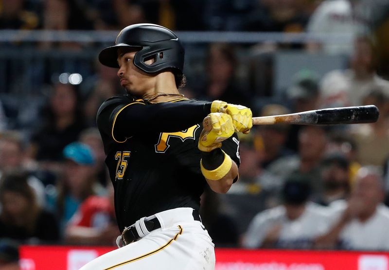 Sep 30, 2023; Pittsburgh, Pennsylvania, USA; Pittsburgh Pirates catcher Endy Rodriguez (25) hits an RBI single against the Miami Marlins during the fifth inning at PNC Park. Mandatory Credit: Charles LeClaire-USA TODAY Sports