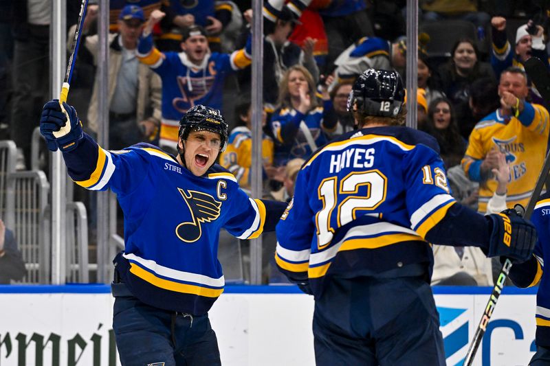 Nov 30, 2023; St. Louis, Missouri, USA;  St. Louis Blues right wing Kevin Hayes (12) is congratulated by center Brayden Schenn (10) after scoring against the Buffalo Sabres during the second period at Enterprise Center. Mandatory Credit: Jeff Curry-USA TODAY Sports