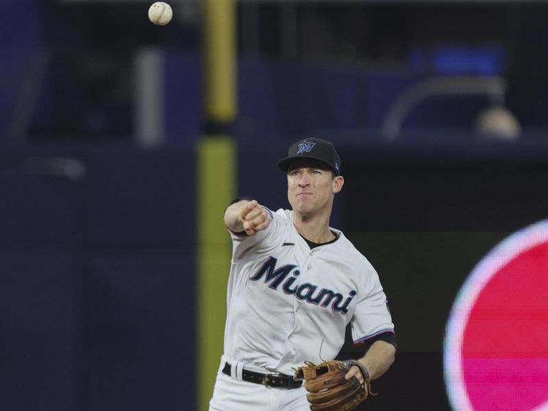 Aug 27, 2023; Miami, Florida, USA; Miami Marlins shortstop Joey Wendle (18) throws to first base and retires third baseman Carter Kieboom (not pictured) during the eighth inning at loanDepot Park. Mandatory Credit: Sam Navarro-USA TODAY Sports