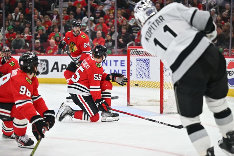 Mar 15, 2024; Chicago, Illinois, USA; Los Angeles Kings forward Anze Kopitar (11) scores into an nearly empty net in the first period against the Chicago Blackhawks at United Center. Mandatory Credit: Jamie Sabau-USA TODAY Sports