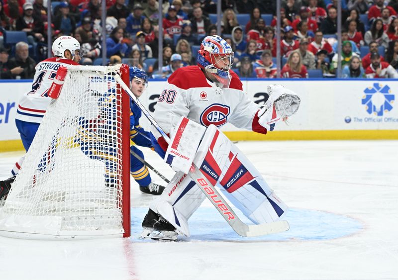 Nov 11, 2024; Buffalo, New York, USA; Montreal Canadiens goaltender Cayden Primeau (30) protects the goal from the Buffalo Sabres in the second period at KeyBank Center. Mandatory Credit: Mark Konezny-Imagn Images