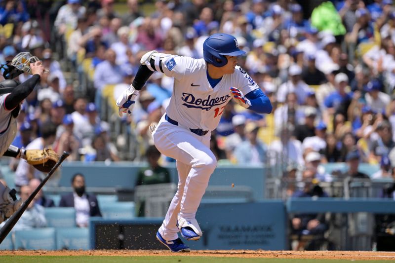 Apr 30, 2025; Los Angeles, California, USA; Los Angeles Dodgers designated hitter Shohei Ohtani (17) hits into a fielder's choice to reach first base against the Miami Marlins at Dodger Stadium. Mandatory Credit: Jayne Kamin-Oncea-Imagn Images