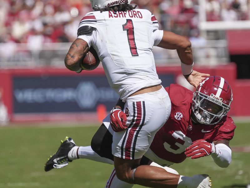Oct 12, 2024; Tuscaloosa, Alabama, USA;  Alabama Crimson Tide defensive back Keon Sabb (3) attempts to bring down South Carolina Gamecocks quarterback Robby Ashford (1) at Bryant-Denny Stadium. Mandatory Credit: Gary Cosby Jr.-Imagn Images