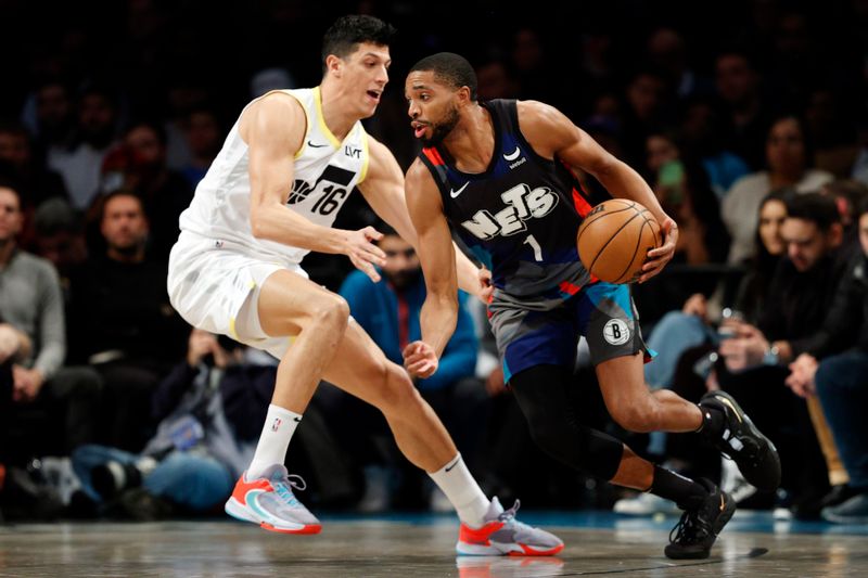 NEW YORK, NEW YORK - JANUARY 29: Mikal Bridges #1 of the Brooklyn Nets dribbles against Simone Fontecchio #16 of the Utah Jazz during the first half at Barclays Center on January 29, 2024 in the Brooklyn borough of New York City. NOTE TO USER: User expressly acknowledges and agrees that, by downloading and/or using this Photograph, user is consenting to the terms and conditions of the Getty Images License Agreement. (Photo by Sarah Stier/Getty Images)