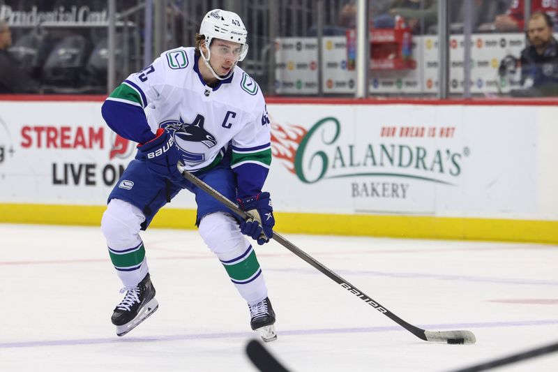 Jan 6, 2024; Newark, New Jersey, USA; Vancouver Canucks defenseman Quinn Hughes (43) skates with the puck against the New Jersey Devils during the first period at Prudential Center. Mandatory Credit: Ed Mulholland-USA TODAY Sports