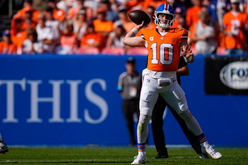 Denver Broncos quarterback Bo Nix passes during the first half of an NFL football game against the Las Vegas Raiders, Sunday, Oct. 6, 2024, in Denver. (AP Photo/David Zalubowski)