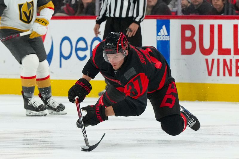 Mar 11, 2023; Raleigh, North Carolina, USA;  Carolina Hurricanes right wing Andrei Svechnikov (37) fall while skates with the puck against the Vegas Golden Knights during the first period at PNC Arena. Mandatory Credit: James Guillory-USA TODAY Sports