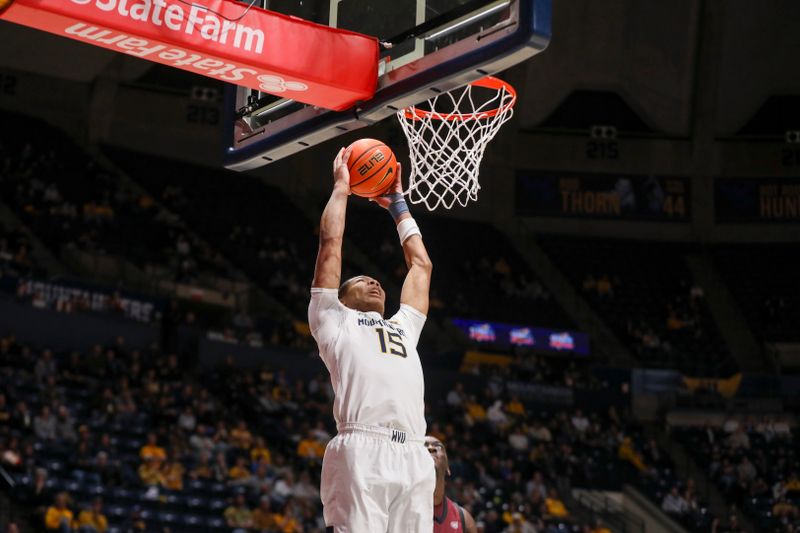 Dec 9, 2025; Morgantown, West Virginia, USA; West Virginia Mountaineers forward Jackson Fields (15) attempts to dunk the ball during the second half against the Little Rock Trojans at Hope Coliseum. Mandatory Credit: Ben Queen-Imagn Images