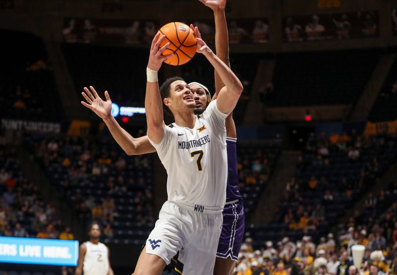 Mar 6, 2024; Morgantown, West Virginia, USA; West Virginia Mountaineers center Jesse Edwards (7) shoots against TCU Horned Frogs forward Xavier Cork (12) during the second half at WVU Coliseum. Mandatory Credit: Ben Queen-USA TODAY Sports