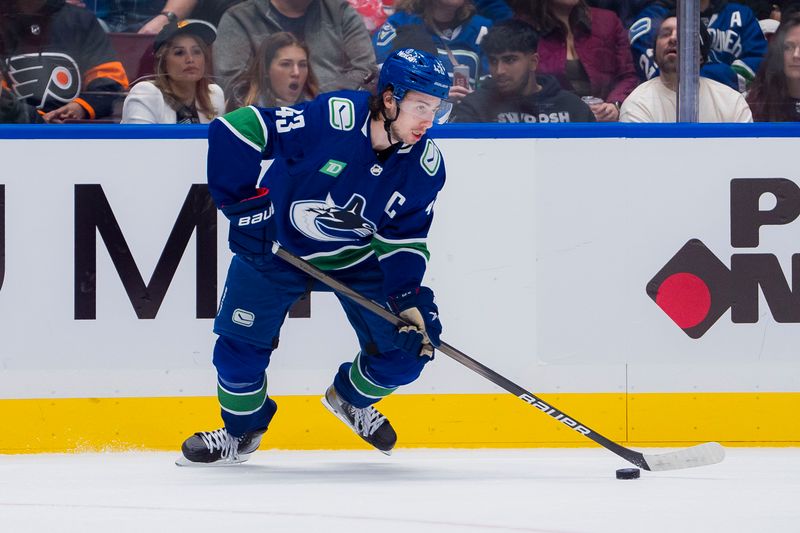 Dec 28, 2023; Vancouver, British Columbia, CAN; Vancouver Canucks defenseman Quinn Hughes (43) handles the puck against the Philadelphia Flyers in the second period at Rogers Arena. Mandatory Credit: Bob Frid-USA TODAY Sports