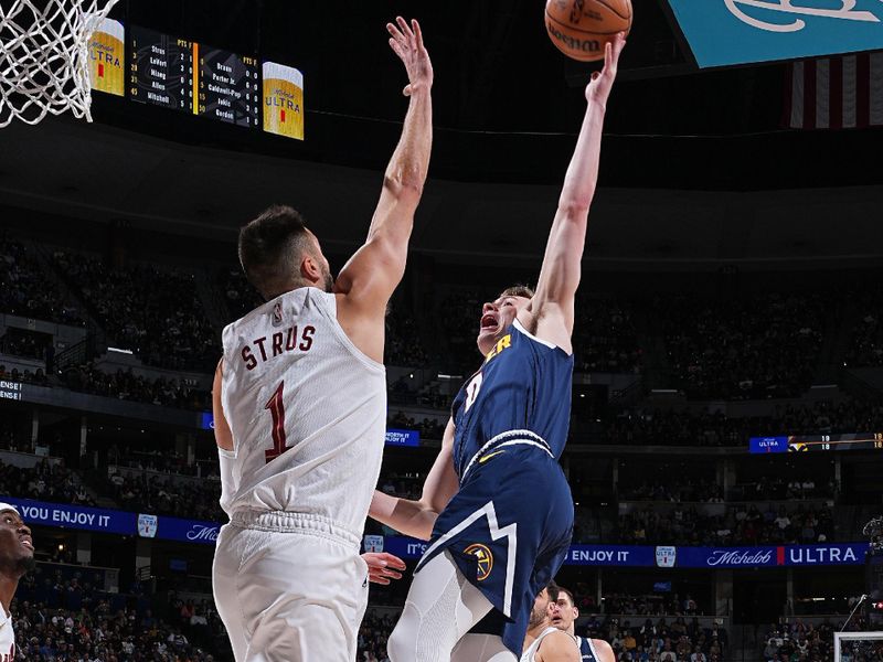 DENVER, CO - MARCH 31: Christian Braun #0 of the Denver Nuggets shoots the ball during the game against the Cleveland Cavaliers on March 31, 2024 at the Ball Arena in Denver, Colorado. NOTE TO USER: User expressly acknowledges and agrees that, by downloading and/or using this Photograph, user is consenting to the terms and conditions of the Getty Images License Agreement. Mandatory Copyright Notice: Copyright 2024 NBAE (Photo by Garrett Ellwood/NBAE via Getty Images)