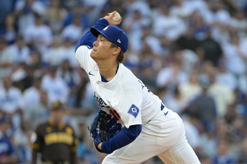 Oct 11, 2024; Los Angeles, California, USA; Los Angeles Dodgers pitcher Yoshinobu Yamamoto (18) pitches against the San Diego Padres in the first inning during game five of the NLDS for the 2024 MLB Playoffs at Dodger Stadium. Mandatory Credit: Jayne Kamin-Oncea-Imagn Images