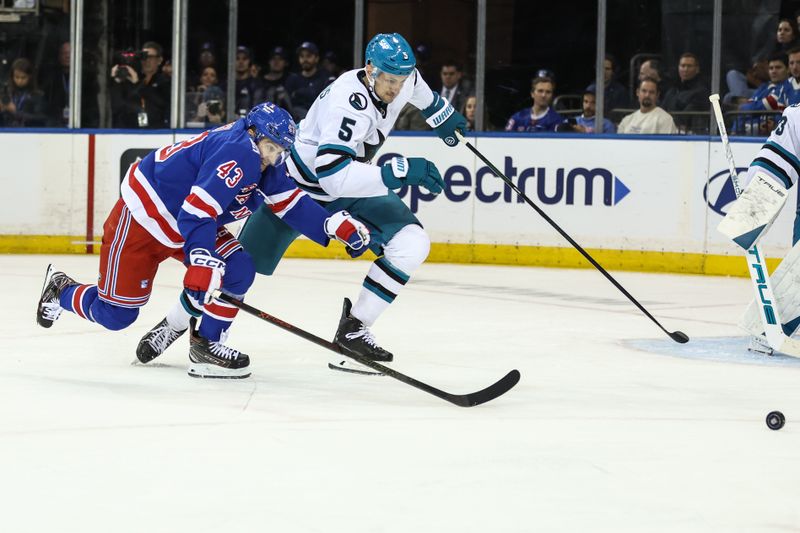 Oct 23, 2025; New York, New York, USA;  New York Rangers left wing Conor Sheary (43) and San Jose Sharks defenseman Vincent Desharnais (5) chase after the puck in the third period at Madison Square Garden. Mandatory Credit: Wendell Cruz-Imagn Images