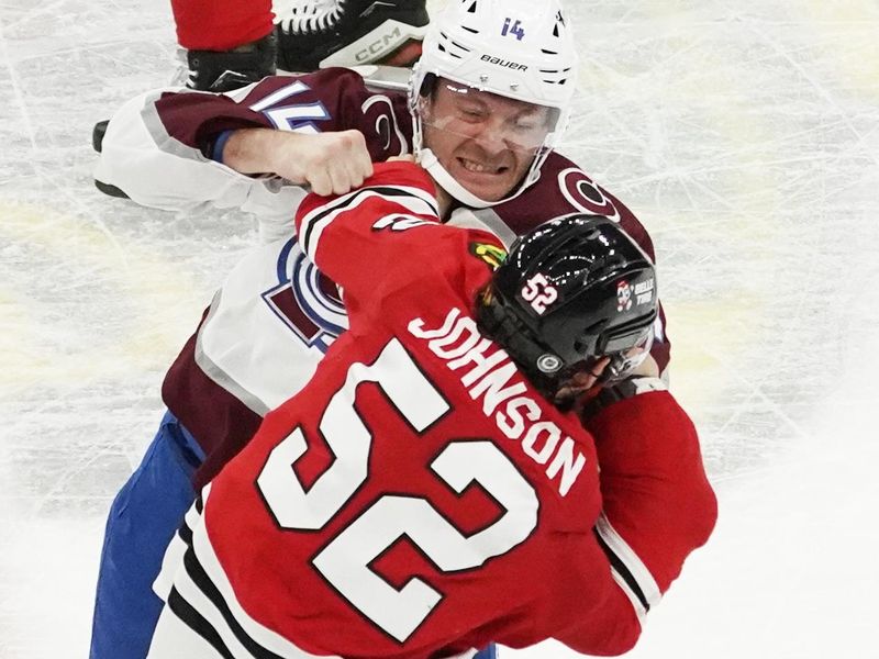 Feb 29, 2024; Chicago, Illinois, USA; Chicago Blackhawks center Reese Johnson (52) and Colorado Avalanche right wing Chris Wagner (14) fight during the second period at United Center. Mandatory Credit: David Banks-USA TODAY Sports