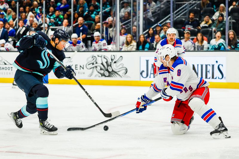 Nov 17, 2024; Seattle, Washington, USA; New York Rangers defenseman Jacob Trouba (8) blocks a shot attempt by Seattle Kraken left wing Andre Burakovsky (95) during the third period at Climate Pledge Arena. Mandatory Credit: Joe Nicholson-Imagn Images