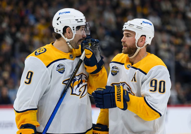 Nov 16, 2025; Stockholm, SWEDEN; Nashville Predators left wing Filip Forsberg (9) talks with Nashville Predators center Ryan O'Reilly (90) against the Pittsburgh Penguins in a Global Series ice hockey game at Avicii Arena. Mandatory Credit: Per Haljestam-Imagn Images