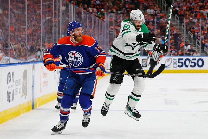 May 27, 2024; Edmonton, Alberta, CAN;   Dallas Stars forward Tyler Sequin (91) tries to jump past Edmonton Oilers defensemen Mattias Ekholm (14) during the second period in game three of the Western Conference Final of the 2024 Stanley Cup Playoffs at Rogers Place. Mandatory Credit: Perry Nelson-USA TODAY Sports